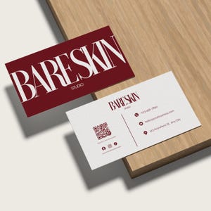 May include: Two business cards with the text "BARE SKIN STUDIO". One card is burgundy with white text, the other is white with burgundy text. The white card includes a QR code and contact information.