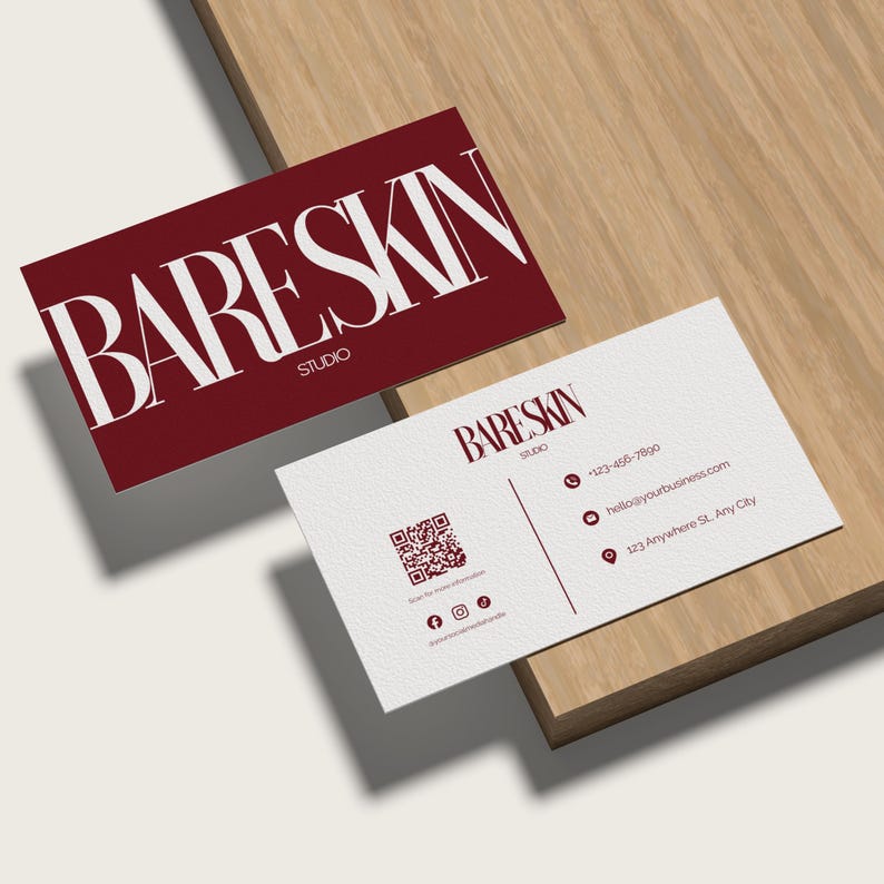 May include: Two business cards with the text "BARE SKIN STUDIO". One card is burgundy with white text, the other is white with burgundy text. The white card includes a QR code and contact information.