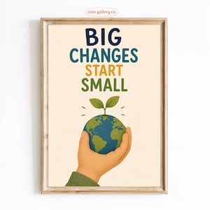 May include: A framed wall art print featuring the text BIG CHANGES START SMALL in dark blue, yellow, and green. Below the text, a hand holds a small blue and green globe with a tiny green sprout growing from the top, set against a cream background.