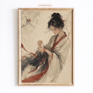 May include: A framed art print featuring a woman in traditional Asian attire. The artwork depicts a woman with dark hair and a red ribbon, with a soft color palette of white, gray, and red. The text "cute gallery co." is in the top left corner.