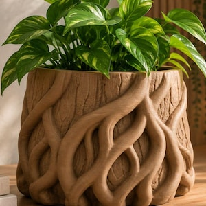 May include: A cylindrical plant pot with a textured brown exterior resembling tree bark and raised, intertwined root-like patterns wrapping around the base. A vibrant green pothos plant with heart-shaped leaves grows from the top of the pot.