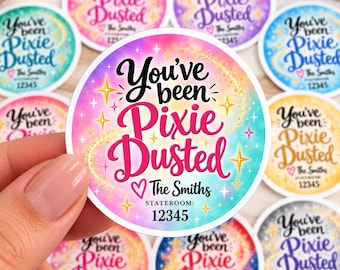 May include: A circular sticker with a gradient background of pink, blue, and yellow. The text reads You've been Pixie Dusted, The Smiths, and STATEROOM: 12345. The design features yellow star accents and a glittery trail effect.