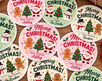 May include: Round Christmas stickers featuring illustrations of Santa Claus, gingerbread people, snowmen, and Christmas trees. The text reads Merry Christmas and includes personalized names such as Ashley, Reuben, and The Smiths.