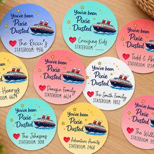 May include: Nine circular stickers in various pastel colors featuring a cruise ship illustration, yellow stars, a red heart, and the text You've been Pixie Dusted. Each sticker includes a space for a family name and a stateroom number.