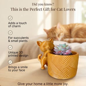 May include: A golden-yellow cat-shaped planter holding a small succulent plant. The planter has a textured design and is on a wooden table. The text on the image says "The Purrfect Planter" and "This is the Perfect Gift for Cat Lovers."
