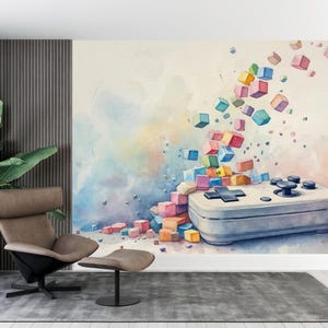 Könnte beinhalten: Aquarell-Wandbild mit einem Videospiel-Controller und bunten, schwebenden Würfeln. Der Controller ist hellblau mit schwarzen Knöpfen. Der Hintergrund hat Pastellfarben, mit einem Stuhl und einer Pflanze im Vordergrund.