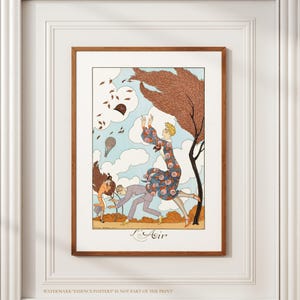 Puede incluir: Una impresión artística enmarcada que presenta una ilustración vintage de personas en un parque con un árbol y globos aerostáticos. La obra de arte presenta a una mujer con un vestido floral. El texto "L'Air" está en la parte inferior.