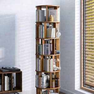 May include: A rotating wooden bookshelf, filled with books and ornaments. The image text reads "17.32" FOOTPRINT PERFECT FOR ANY CORNER". The bookshelf has a footprint of approximately 44 cm, the size of a large pizza.