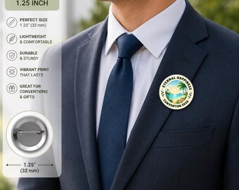May include: A round button pin, 1.25 inches (32 mm) in diameter, featuring a tropical beach scene with the text "Eternal Happiness Convention 2026." The pin is attached to a navy blue suit jacket.