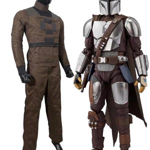 May include: A brown long-sleeved shirt and matching trousers on a black mannequin next to a Mandalorian action figure wearing silver armor, a brown cape, and a utility belt with a holster, featuring a metallic helmet and detailed protective gear.