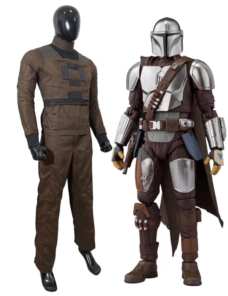 May include: A brown long-sleeved shirt and matching trousers on a black mannequin next to a Mandalorian action figure wearing silver armor, a brown cape, and a utility belt with a holster, featuring a metallic helmet and detailed protective gear.