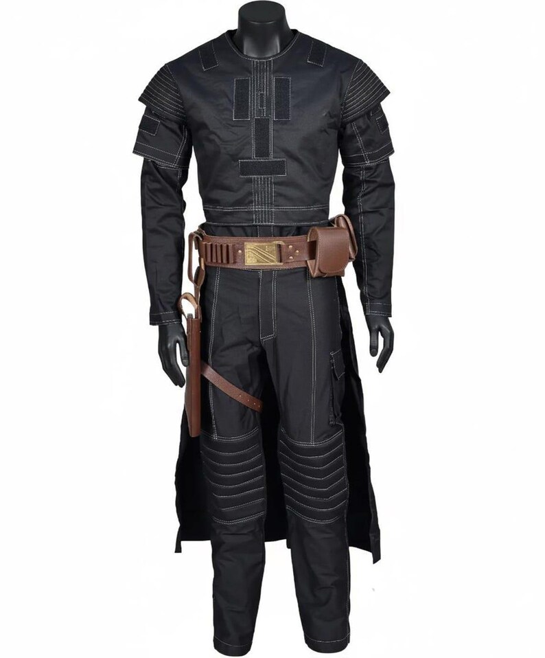 May include: A black long-sleeved shirt and matching trousers set featuring white contrast stitching, shoulder padding, and quilted knee panels. A brown leather utility belt with a gold buckle, attached pouches, and a holster is worn at the waist.