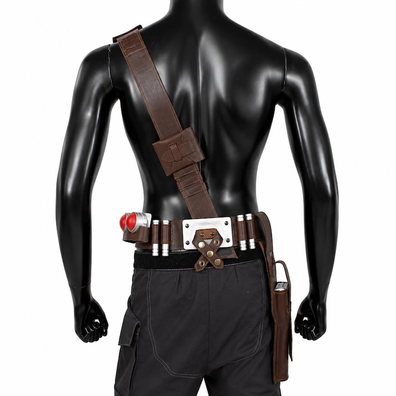 May include: A brown utility belt and shoulder strap set featuring a rectangular silver metal plate, multiple cylindrical silver accents, two prominent red spherical components, and a brown holster attached to the side of the belt.