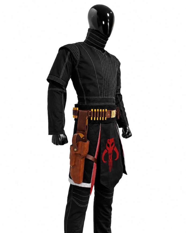 May include: A black costume featuring a high-neck tunic with white stitching, matching trousers, and a brown leather belt with gold-colored ammunition loops and a holster. A black apron with a red skull emblem hangs over the front of the outfit.