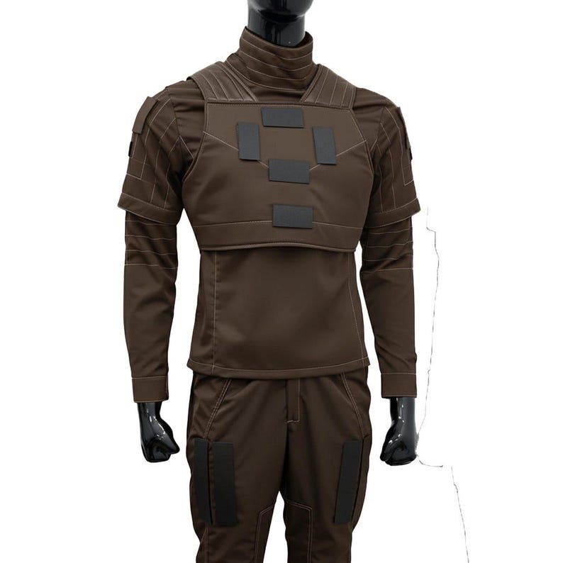 Pu&ograve; includere: Un set di uniforme in stile tattico marrone composto da una maglia a maniche lunghe con collo alto, una piastra pettorale con toppe rettangolari nere e pantaloni abbinati con ulteriori toppe rettangolari nere sulle cosce e sulle spalle.