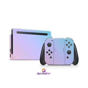 May include: A gaming console and controllers with a gradient design in shades of blue, purple, and pink. The controllers have black accents and buttons. The brand name "SKINIFY" is displayed in orange and purple.