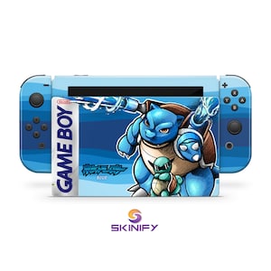 May include: A blue Nintendo Switch console skin featuring a cartoon illustration of a blue turtle-like creature. The skin has a Game Boy label design with the text "GAME BOY" and "BLUE". The console's controllers are also blue.