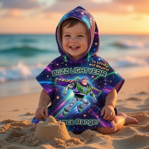 May include: A child's hooded poncho featuring Buzz Lightyear. The poncho has a space-themed design with the character's image and the text "Buzz Lightyear Space Ranger". The poncho is purple, blue, and green, with the words "To Infinity and Beyond".