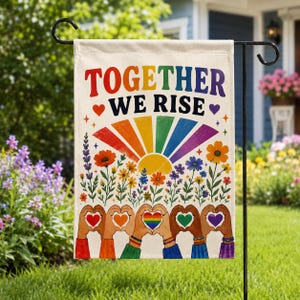 May include: A rectangular garden flag featuring the text TOGETHER WE RISE in bold letters above a rainbow sunburst. Below are colourful wildflowers and a row of hands forming heart shapes with various coloured sleeves and small heart icons.
