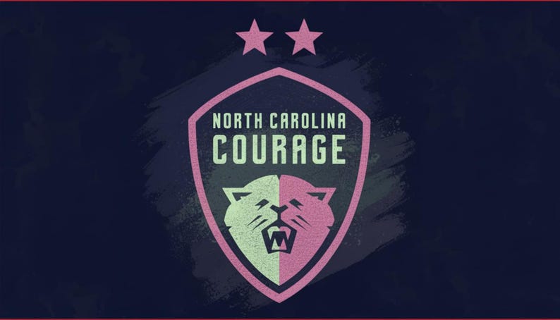 May include: A shield-shaped logo for the North Carolina Courage soccer team. The logo features a pink and white cougar head, the team name, and two pink stars on a navy blue background. The design has a distressed, textured look.