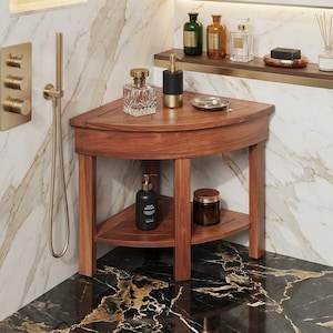 May include: A wooden corner shower bench with two shelves. The bench is made of dark wood and is filled with toiletries, including perfume bottles, soap, and lotion. The shower fixtures are gold-toned.