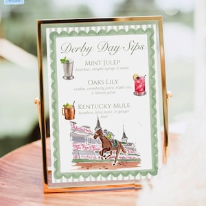 May include: A framed sign with the text "Derby Day Sips" and illustrations of cocktails. The sign lists three drink recipes: Mint Julep, Oaks Lily, and Kentucky Mule. The frame is gold-colored, and the sign has a green border.