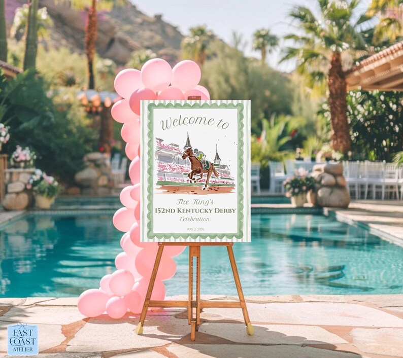 May include: A wooden easel displays a sign with the text "Welcome to The King's 152nd Kentucky Derby Celebration." The sign features a horse race illustration, surrounded by a green border. Pink balloons decorate the scene near a pool.