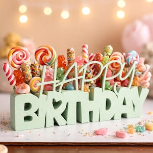 May include: A mint green "Happy Birthday" sign filled with colorful candies. The sign features the words "Happy Birthday" in a playful font, with a variety of lollipops, gummy bears, and other sweets arranged on top.