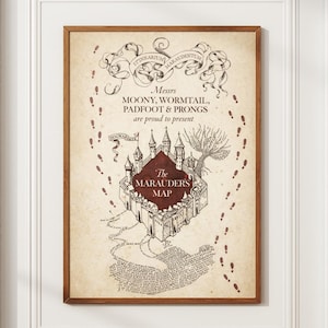 May include: A framed print of The Marauder's Map from the Harry Potter series. The map is a parchment-like color with a detailed illustration of Hogwarts Castle. Text includes "Messrs Moony, Wormtail, Padfoot & Prongs are proud to present The Marauders Map."