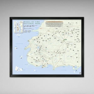 May include: Framed map of the Wheel of Time National Park, featuring a detailed cartographic representation of the park's layout. The map includes roads, landmarks, and geographical features, with the title "Wheel of Time National Park" at the top. The map is framed in a black border.