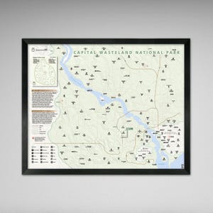 May include: Framed map print of the Capital Wasteland National Park, featuring a detailed topographical layout with roads, rivers, and landmarks. The map includes the text "CAPITAL WASTELAND NATIONAL PARK" at the top. The map is in a black frame.