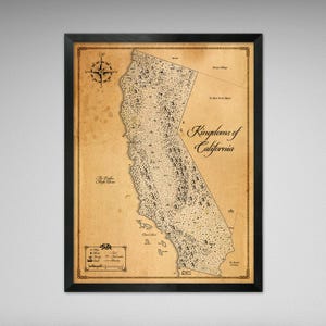 May include: A framed vintage map of California, with a compass rose and the text "Kingdoms of California." The map has a sepia tone with black details and is in a black frame. The map includes a legend and various place names.