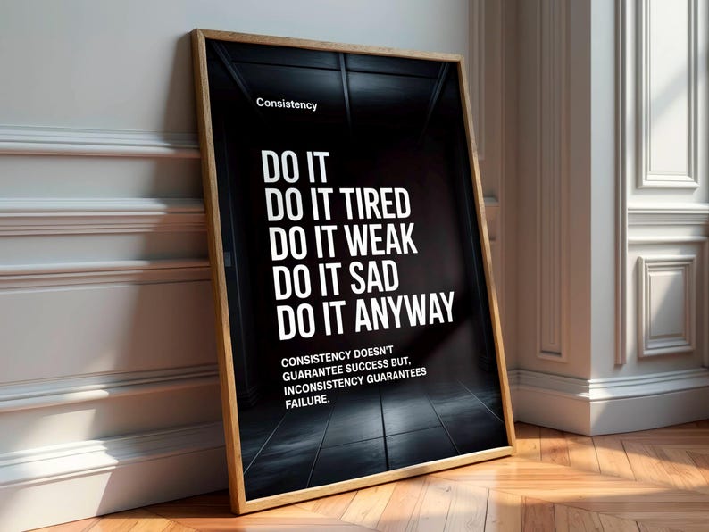 May include: A framed motivational poster with a black background and white text. The poster reads "DO IT" followed by "DO IT TIRED, WEAK, SAD, ANYWAY." The text "Consistency" is at the top, and a quote about consistency is at the bottom.