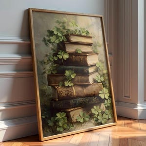 May include: A framed artwork depicts a stack of antique books adorned with green shamrocks. The books, in varying shades of brown and green, are arranged in a vertical pile. The artwork is set against a muted, neutral background, with a wooden frame.
