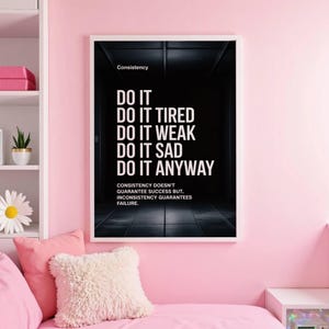 May include: A framed motivational poster with the word "Consistency" at the top. The poster features the text "DO IT, DO IT TIRED, DO IT WEAK, DO IT SAD, DO IT ANYWAY" in white font against a dark background. The bottom text reads "Consistency doesn't guarantee success but, inconsistency guarantees failure."