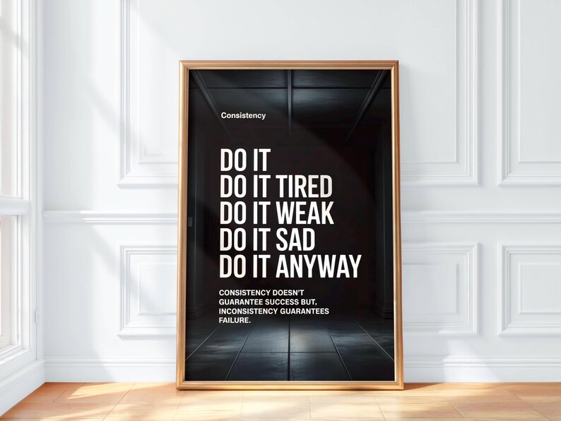 May include: Framed motivational poster with a black background and white text. The poster reads "DO IT" followed by "DO IT TIRED, WEAK, SAD, ANYWAY." The word "Consistency" is at the top. The bottom text states "Consistency doesn't guarantee success but, inconsistency guarantees failure."