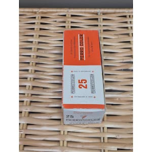 May include: A rectangular Perro Color box containing 25 slide mounts. The packaging is orange and white with black text, featuring the brand name, the number 25, and the phrase Made in Switzerland. It specifies 5x5 cm and 24x36 mm dimensions.