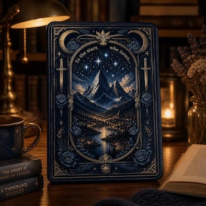 May include: A rectangular book cover featuring a dark blue and gold ornate frame with roses and swords. The central illustration depicts a mountain range under a starry night sky with a lake below. The text reads, To the stars who listen.