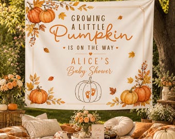 May include: A white fabric backdrop for a baby shower featuring orange pumpkin illustrations, autumn leaves, and the text: Growing a little Pumpkin is on the way, Alice's Baby Shower. A central pumpkin graphic displays two small baby footprints.