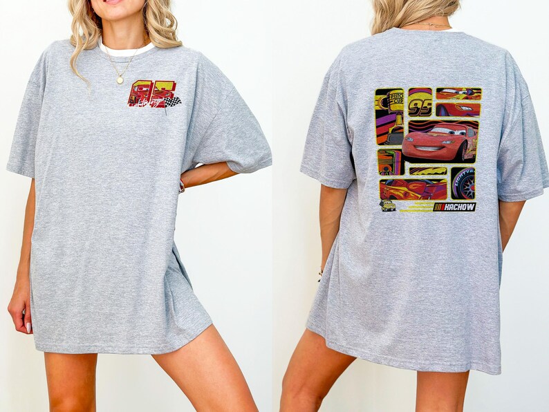 May include: A light gray t-shirt featuring a graphic of the character Lightning McQueen from the movie Cars. The front of the shirt has the number 95 and a checkered flag. The back of the shirt has a collage of images of Lightning McQueen.