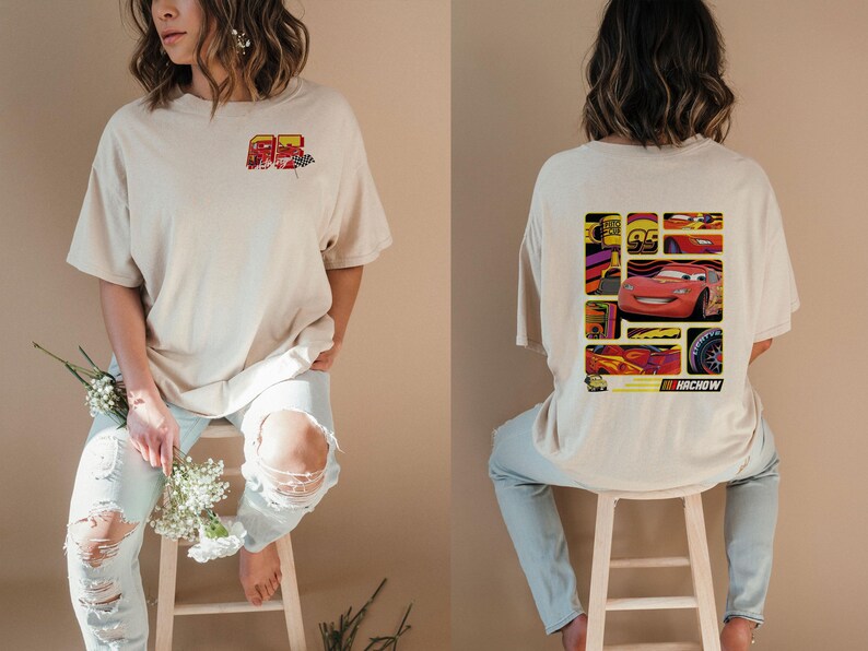 May include: Beige t-shirt featuring a graphic of a red race car with the number 95. The back of the shirt displays a collage of images related to the car, including the text "KA-CHOW".