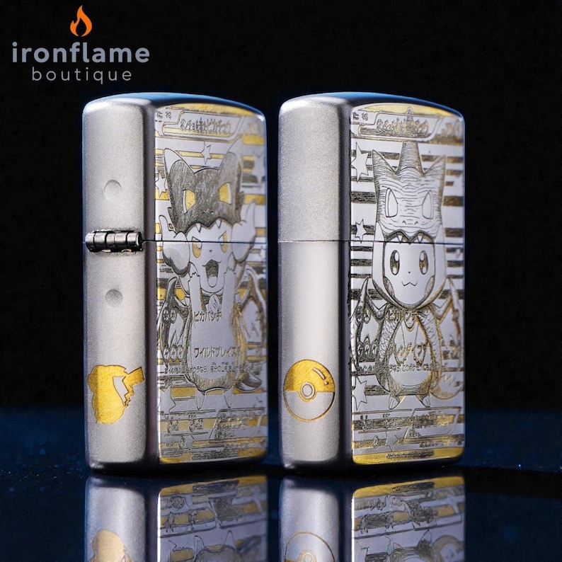 May include: Two silver-colored lighters with detailed engraved designs. One lighter features a cartoon character with a cat-like appearance, while the other showcases a different character. The lighters have gold accents and Japanese text.