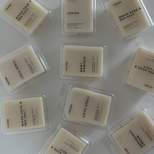 May include: A collection of scented wax sachets in clear plastic packaging. The sachets are rectangular and labelled with scents such as "Wood Sage & Sea Salt," "Lemon," and "Baby Powder." The brand name "I'M STORE" is printed on the packaging.
