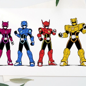 May include: Greeting card featuring four colorful Power Ranger-style characters. The characters are in magenta, blue, red, and gold, each with a unique helmet design and black accents. The card is on a white surface with green leaves.