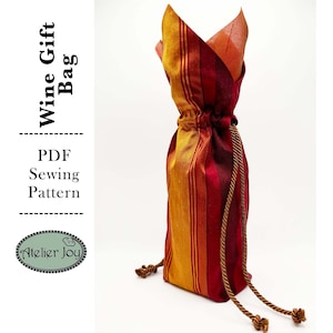 May include: A PDF sewing pattern for a wine gift bag. The bag is made of striped fabric in shades of red, orange, and yellow. The bag has a drawstring closure and a decorative cord.