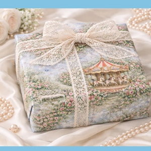May include: A square gift box wrapped in floral paper, featuring a carousel illustration, tied with a cream lace ribbon and bow. Pearls and white roses are in the background.