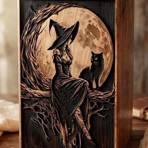 A wooden cremation urn engraved with a witch in a hat sitting on a tree branch under a large moon, accompanied by a black cat.