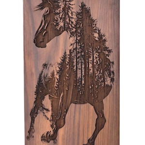 A rectangular wooden panel laser-engraved with the silhouette of a horse filled with a dense forest scene.