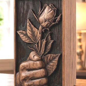 A wooden urn box featuring a raised 3D carving of a hand holding a single rose.