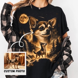 May include: A black t-shirt featuring a large graphic print of a chihuahua dog in a forest landscape under a full moon. The design includes a smaller inset box at the bottom left corner displaying a photograph of the same dog with the text CUSTOM PHOTO.